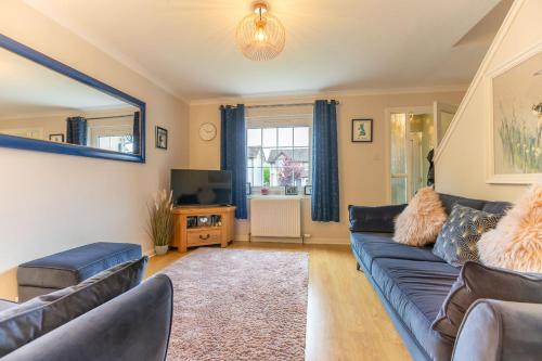 un soggiorno con divano blu e TV di Inverness Holiday Retreat - 2 Bedroom a Inverness