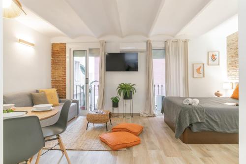 a living room with a bed and a dining room at Carretes 1 in Barcelona