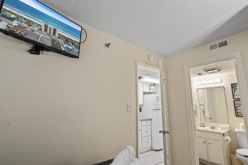 a bathroom with a flat screen tv on the wall at Beautiful 2 Bedroom Apartment in Cherry Grove with Stunning Views Buena Vista 402 in Myrtle Beach