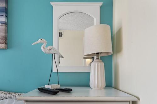 a table with a lamp and a mirror on it at Beautiful 2 Bedroom Apartment in Cherry Grove with Stunning Views Buena Vista 402 in Myrtle Beach