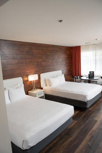 a hotel room with two beds and a window at Carson Valley Motor Lodge and Suites in Minden