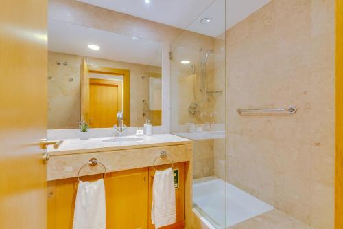 a bathroom with a sink and a shower at AL - Apartamento Vila Sol N in Vilamoura