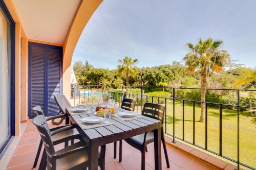a dining table on the balcony of a house at AL - Apartamento Vila Sol N in Vilamoura