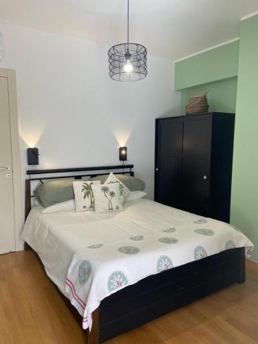 a bedroom with a large bed with a black cabinet at Casa del Porto in Pesaro