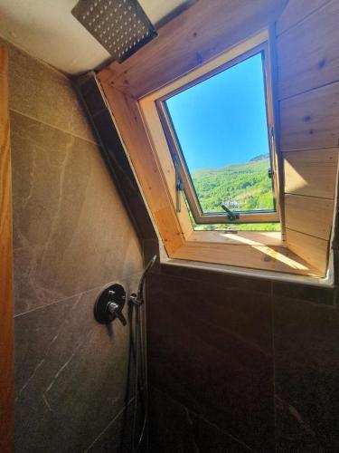 a bathroom with a window on the wall and a shower at Villa Davisol in Theth