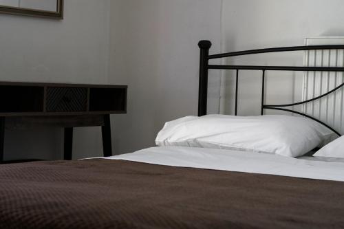 a bedroom with a bed and a wooden table at Sea Harmony in Adelianos Kampos
