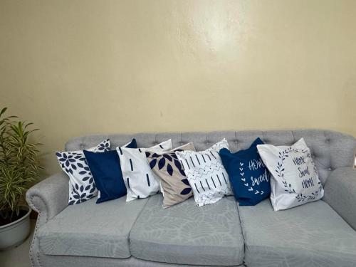 a bunch of pillows sitting on a couch at TenEighteen Family Vacation Home in Dipolog