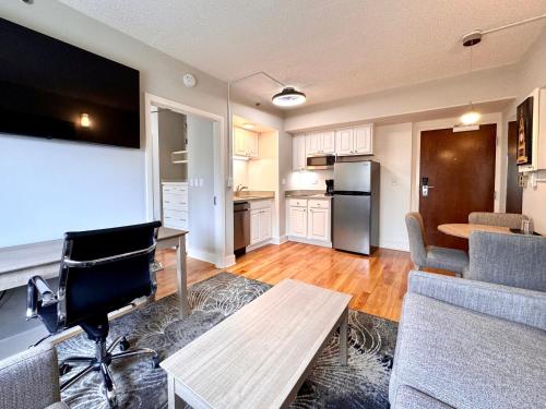 a kitchen and living room with a table and a couch at The GEM Museum Suites in Evanston