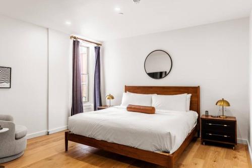 a bedroom with a bed with a mirror and a chair at King Bed, Historic DTWN Hotel, Coffee Shop, Room # 202 in Bangor