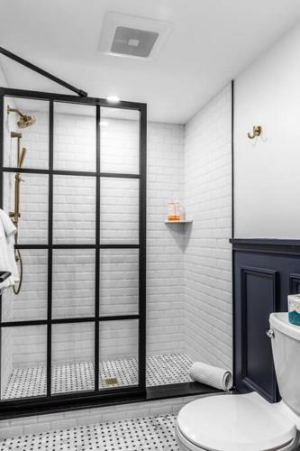 a bathroom with a glass shower with a toilet at King Bed, Historic DTWN Hotel, Coffee Shop, Room # 202 in Bangor