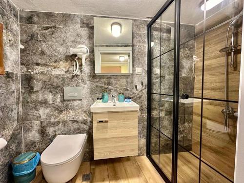 a bathroom with a toilet and a sink and a shower at Golden Stay Boutique Hotel Taksim in Istanbul