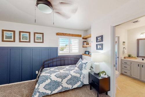 a bedroom with a bed with a blue wall at Oro Valley Vista in Oro Valley