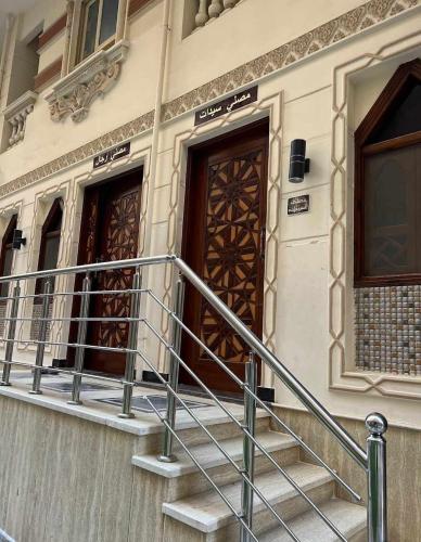 a set of stairs leading to two doors on a building at شقة للايجار بكمبوند البركة بالأسكندرية مصر in Alexandria