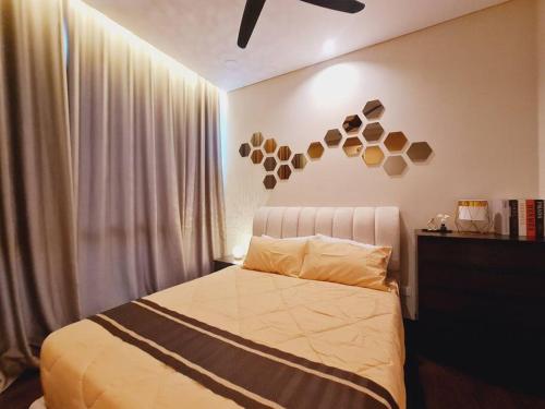 a bedroom with a bed with a sign on the wall at New!2-7pax 2BR SKS Pavillion Condo near JB Customs in Johor Bahru