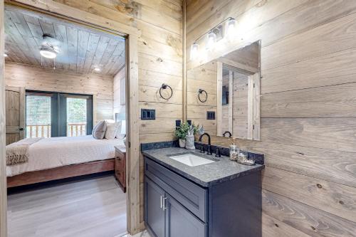 a bathroom with a sink and a bed in a room at Valley Creek Castle in Pigeon Forge