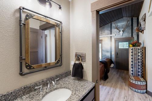 a bathroom with a sink and a mirror at Rost Place Round-Up in Sturgis