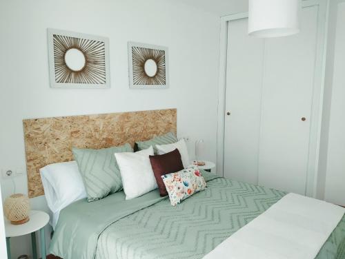 a bedroom with a bed with two mirrors on the wall at La Berrea Cabañaquinta in Aller