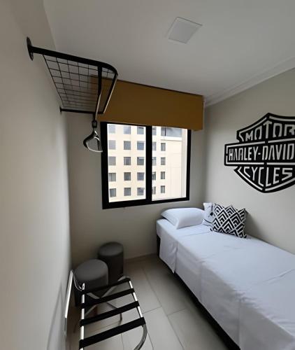 a bedroom with two beds and a window at Airfamily Congonhas in Sao Paulo
