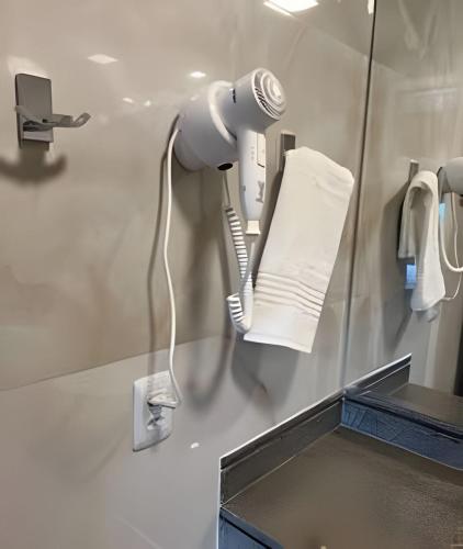 a hair dryer on a wall in a bathroom at Airfamily Congonhas in Sao Paulo