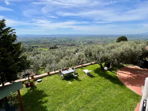 a view of a garden with a table and chairs at Casa della Noce in Vinci
