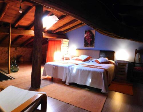 a bedroom with a large bed in a room at Casa Rural 1904 in Tubilla del Lago