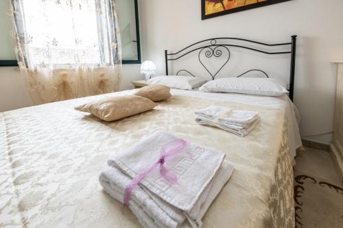 a bedroom with a bed with towels on it at L'alba di Santa Cesarea in Santa Cesarea Terme