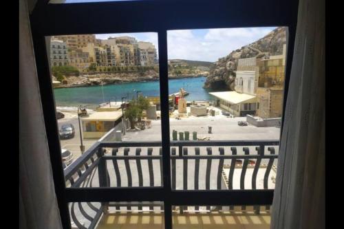 a view of a river from a window at Cozy beachside in Xlendi