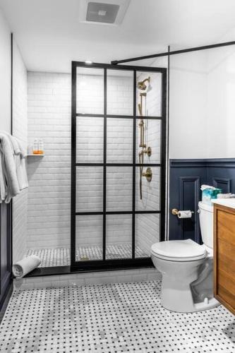 a bathroom with a shower with a toilet in it at King Bed , DTWN, 50 in Roku TV , Fiber Internet, Room # 203 in Bangor