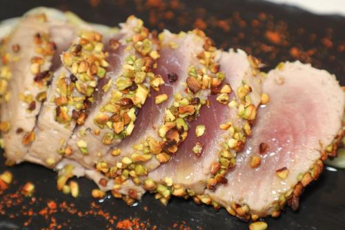 a piece of meat with nuts on top of it at Il Podere Del Germano Reale in Coriano