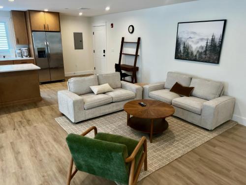 a living room with two couches and a table at Montgomery Modern Luxury Stays in Montgomery