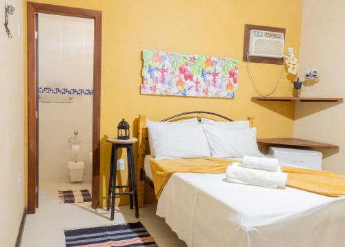 a bedroom with two beds in a room at Pousada Das Araras in Itaúnas