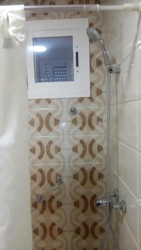 a bathroom with a shower with a microwave at La viña de camarata in Aguilar de la Frontera
