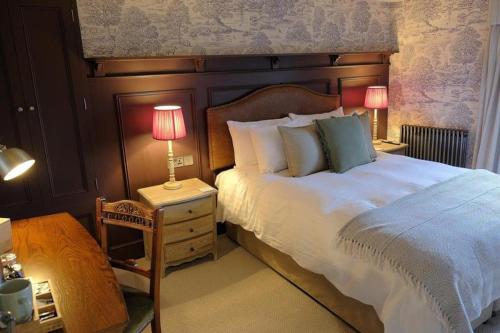 a bedroom with a large bed and two lamps on tables at The Falcon Inn in Scarborough