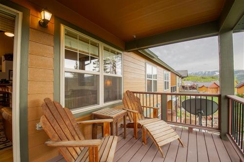a porch with two chairs and a table on a balcony at 45 Reunion Court - Rendezvous in Fraser
