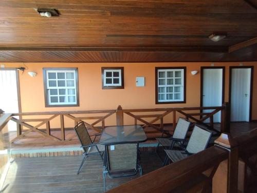 a balcony with a table and chairs on it at Pousada Enseada da Vila in Cabo Frio