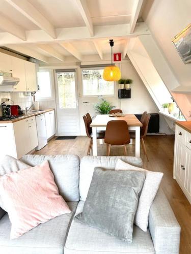 a living room with a couch and a table at La petite maison Durbuy in Durbuy