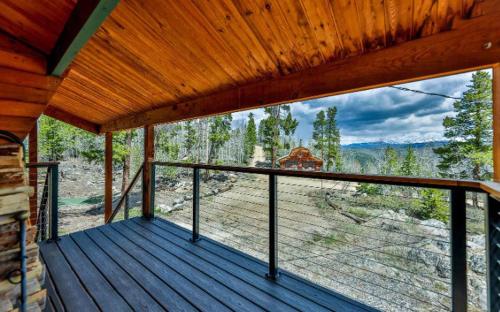 a porch of a cabin with a view of a forest at 273 Fallen Rock in Tabernash