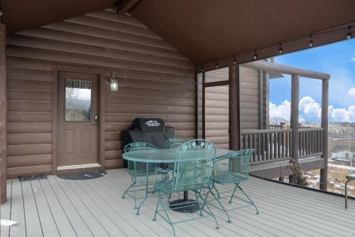 a patio with a table and chairs on a deck at 2665 Golden Edge Drive in Kremmling