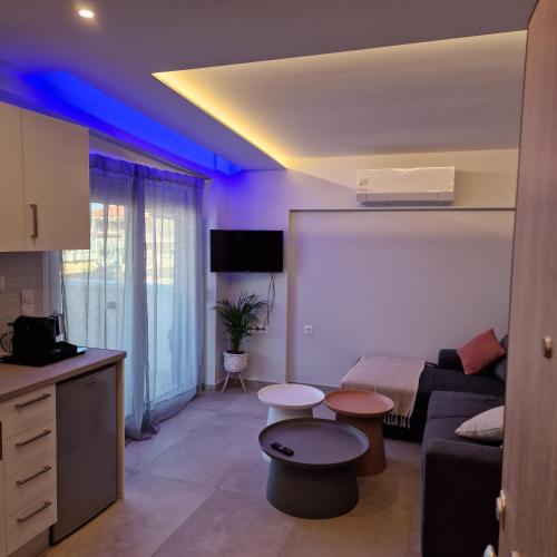 a living room with a couch and a table at Panorama Inn Hotel in Paralia Katerinis