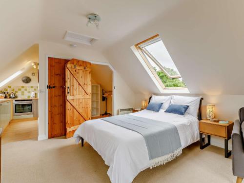 een slaapkamer met een groot bed en een raam bij 1 Bed in Cullompton 79004 in Cullompton