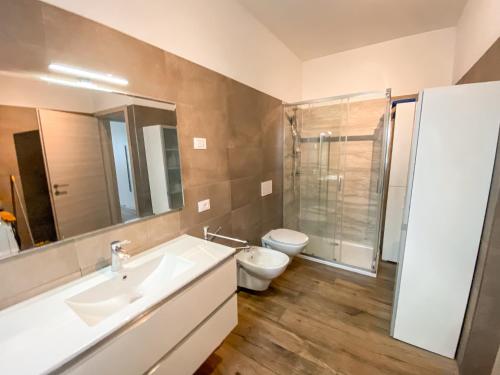 a bathroom with a sink and a toilet and a shower at Lake View Levico in Levico Terme