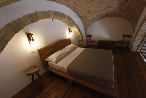 a bedroom with a bed in a brick wall at Casa Alexina in Lesina