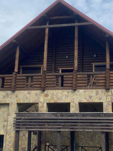 a building with a wooden balcony on top of it at Hetman Hotel in Kamianets-Podilskyi