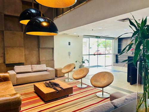 a living room with a couch and chairs and a table at Naoum Hotel in Brasilia