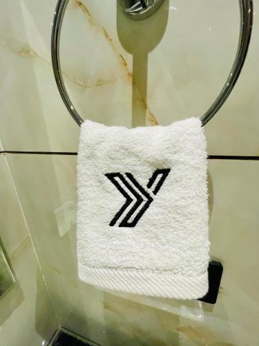 a white towel with a z sign on it at Yarrows, Narkanda, A boutique stay in Nārkanda