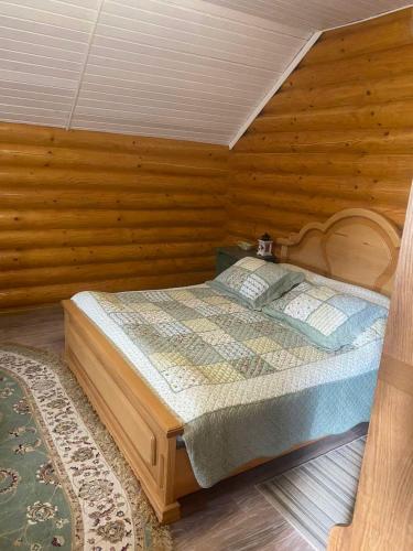 a bedroom with a bed in a wooden room at Hetman Hotel in Kamianets-Podilskyi
