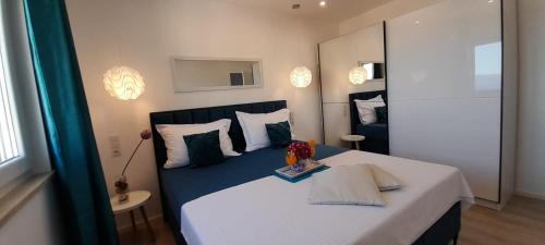 Postel nebo postele na pokoji v ubytování Apartments San Paulo