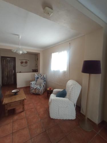 a living room with two chairs and a table at Hostal R-Conecta in Cuevas de San Marcos