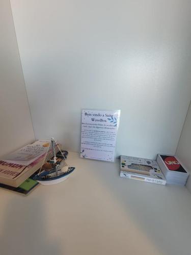 a group of books sitting on top of a table at WaveBox Suítes Container in São Francisco do Sul