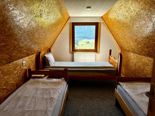 a room with two beds and a window at Holiday home Kraljica in Vlasic